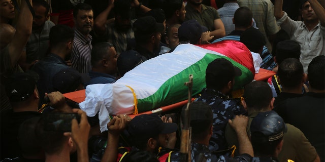 Security forces loyal to Hamas transporting the body of one of the police officers killed during his funeral in Gaza City on Wednesday.
