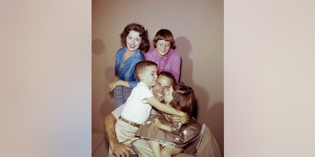 Shirley Temple, son Charles Black Jr., daughter Susan Agar, husband Charles A. Black, and daughter Lori Black at home in 1957. (Photo by Herb Ball/NBC/NBCU Photo Bank via Getty Images)