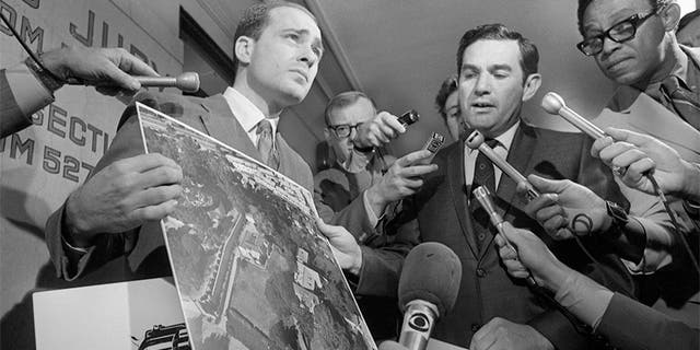 Deputy District Attorneys Aaron Stovitz (left) and Vince Bugliosi display an aerial photograph of the home of Leno and Rosemary LaBianca, 1969. — Getty