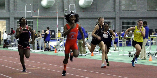 FILE - In this Feb. 7, 2019 file photo, Bloomfield High School transgender athlete Terry Miller, second from left, wins the final of the 55-meter dash over transgender athlete Andraya Yearwood, far left, and other runners in the Connecticut girls Class S indoor track meet at Hillhouse High School in New Haven, Conn.  (AP Photo/Pat Eaton-Robb, File)