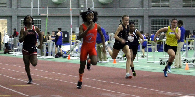 FILE - In this Feb. 7, 2019 file photo, Bloomfield High School transgender athlete Terry Miller, second from left, wins the final of the 55-meter dash over transgender athlete Andraya Yearwood, far left, and other runners in the Connecticut girls Class S indoor track meet at Hillhouse High School in New Haven, Conn.  (AP Photo/Pat Eaton-Robb, File)