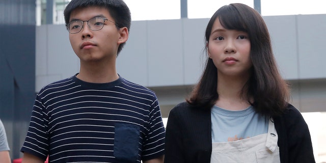 Pro-democracy activists Joshua Wong, left, and Agnes Chow address reporters outside a government office in Hong Kong, June 18, 2019. (Associated Press)