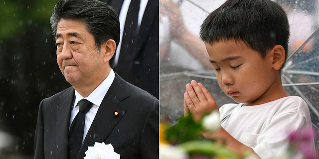 Japanese Prime Minister Shinzo Abe (left) leaves after his speech during a ceremony to mark the 74th anniversary of the atomic bombing at the Hiroshima Peace Memorial Park in Hiroshima, western Japan Tuesday, Aug. 6, 2019. A boy prays (right) for the atomic bomb victims in front of the cenotaph at the Hiroshima Peace Memorial Park in Hiroshima.