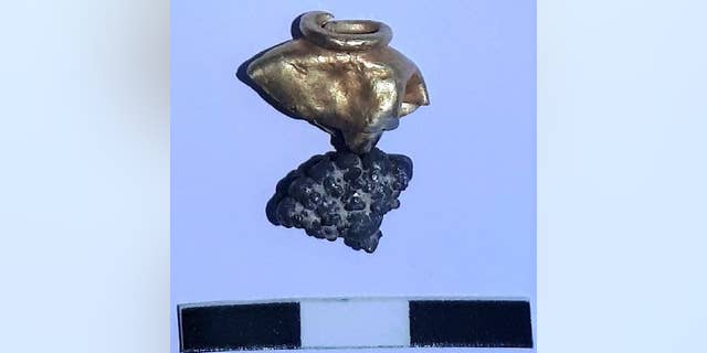 The earring or tassel ornament discovered at the excavation site.