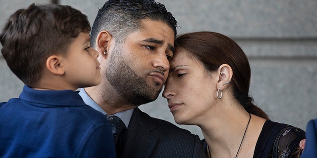 Juan Rodriguez, holding his son Tristan, leaves Bronx Criminal Court with his wife Marissa after a hearing, Thursday, Aug. 1, 2019 in New York. (AP Photo/Mark Lennihan)