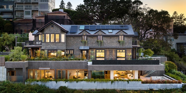 The outdoor features include four-car garage, entrainment center, dining area and glass elevator to take you between floors.