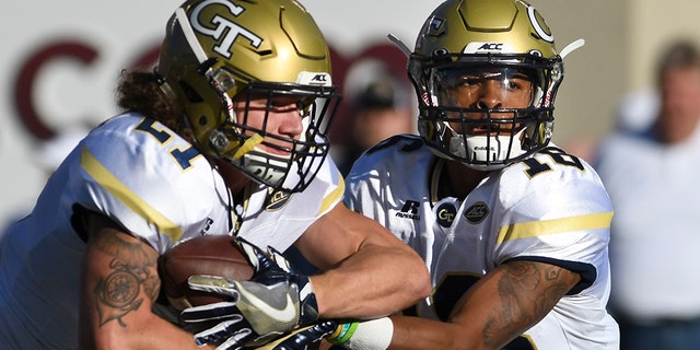 BLACKSBURG, VA - NOVEMBER 12: Running back Quaide Weimerskirch #21 of the Georgia Tech Yellow Jackets receives the ball from quarterback Lucas Johnson #18 prior to the game against the Virginia Tech Hokies at Lane Stadium on November 12, 2016 in Blacksburg, Virginia. Georgia Tech defeated Virginia Tech 30-20. (Photo by Michael Shroyer/Getty Images)