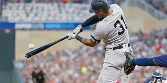 New York Yankees' Aaron Hicks hits an RBI single off Minnesota Twins pitcher Jake Odorizzi in the fourth inning of a baseball game Wednesday, July 24, 2019, in Minneapolis. (AP Photo/Jim Mone)