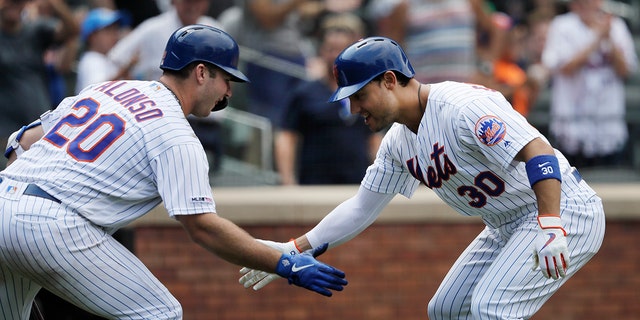 New York Mets' Michael Conforto, right, is greeted by teammate Pete Alonso after hitting a solo run home run against the Miami Marlins in the seventh inning of a baseball game, Wednesday, Aug. 7, 2019 in New York. (AP Photo/Mark Lennihan)