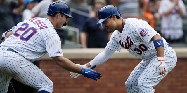 New York Mets' Michael Conforto, right, is greeted by teammate Pete Alonso after hitting a solo run home run against the Miami Marlins in the seventh inning of a baseball game, Wednesday, Aug. 7, 2019 in New York. (AP Photo/Mark Lennihan)