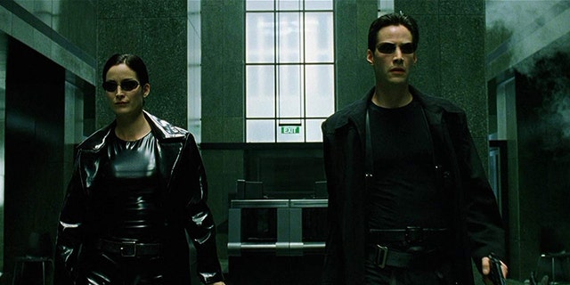 Carrie-Anne Moss as Trinity and Keanu Reeves as Neo. 