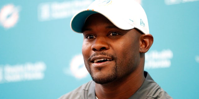 Miami Dolphins head coach Brian Flores speaks to members of the media before the start of practice at the NFL football team's training camp, Monday, Aug. 19, 2019, in Davie, Fla. (AP Photo/Wilfredo Lee)