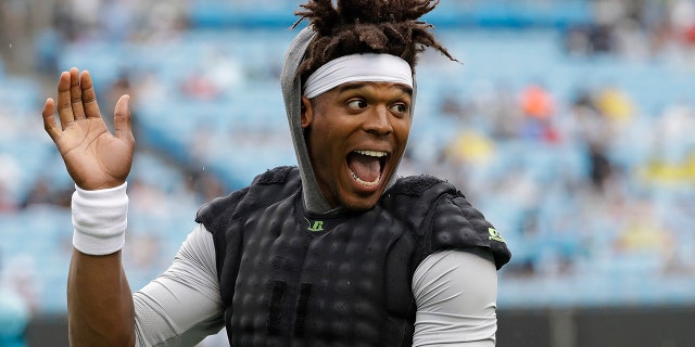 Carolina Panthers quarterback Cam Newton waves to the crowd during a Fan Fest practice at the NFL football team's training camp in Charlotte, N.C., Friday, Aug. 2, 2019. (AP Photo/Chuck Burton)