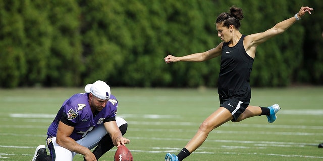Sam Koch of Baltimore Ravens holds the ball for American football player Carli Lloyd while she was trying to score a goal after the Philadelphia Eagles and as the Baltimore Ravens staged an NFL football training in Philadelphia on Tuesday August 20th 2019. 