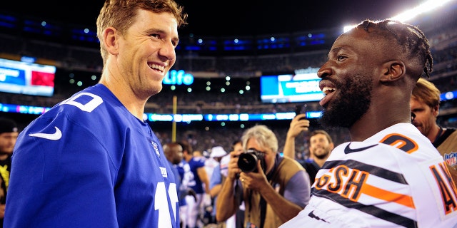 New York Giants quarterback Eli Manning (10) greets Chicago Bears cornerback Prince Amukamara (20) after a preseason NFL football game, Friday, Aug. 16, 2019, in East Rutherford, N.J. The Giants won 32-13.(AP Photo/Sarah Stier)