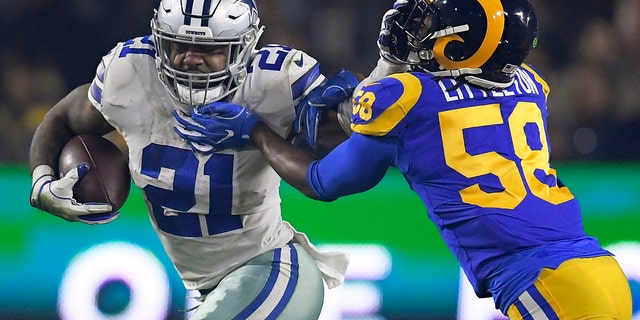 FILE - In this Jan. 12, 2019, file photo, Dallas Cowboys running back Ezekiel Elliott pushes off Los Angeles Rams inside linebacker Cory Littleton during the first half in an NFL divisional football playoff game in Los Angeles. (AP Photo/Mark J. Terrill, File)