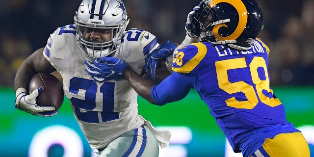 FILE - In this Jan. 12, 2019, file photo, Dallas Cowboys running back Ezekiel Elliott pushes off Los Angeles Rams inside linebacker Cory Littleton during the first half in an NFL divisional football playoff game in Los Angeles. (AP Photo/Mark J. Terrill, File)