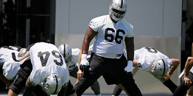 FILE - In this June 11, 2019, file photo, Oakland Raiders offensive guard Gabe Jackson (66) and teammates stretch during the NFL football team's minicamp in Alameda, Calif. (AP Photo/Eric Risberg, File)