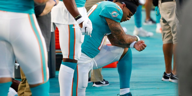 Miami Dolphins wide receiver Kenny Stills kneels during the national anthem before the team's preseason NFL football game against the Atlanta Falcons, Thursday, Aug. 8, 2019, in Miami Gardens, Fla. (AP Photo/Wilfredo Lee)