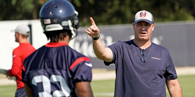 Houston Texans coach Bill O'Brien, right, talks to cornerback Lonnie Johnson Jr. (32) during an NFL football training camp practice Thursday, July 25, 2019, in Houston.