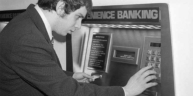 (Original Caption) 6/7/1976-New York, NY-: Banks across the nation are abandoning their old image and their bricks-and-mortar concept of doing business, and are trying to lure new customers with push-button banking. Using a coded plastic card in the computerized teller machine such as this one in Grand Central Station, a customer can deposit or withdraw money, transfer funds, and even make a loan. (Bettmann/Getty)