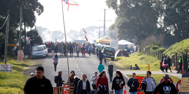 Protestors gather at Ihumātao as they stand to fight a proposed Fletcher Building housing development on July 25, 2019 in Auckland, New Zealand. The site near Auckland Airport is due to be developed by Fletcher Building but has been the subject of a dispute and an occupation after an eviction notice was served against occupiers earlier in the week.