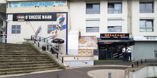 Policemen stand in front of the eatery on Saturday where a waiter was shot dead by a customer allegedly angry at having to wait for a sandwich, in the eastern Paris suburb of Noisy-le-Grand.
