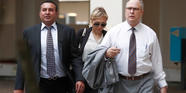 Lawyers Lawrence Hashish, left, David Frankel, right, and paralegal Juliana Marulanda, center, entering Broward County Jail on Monday.