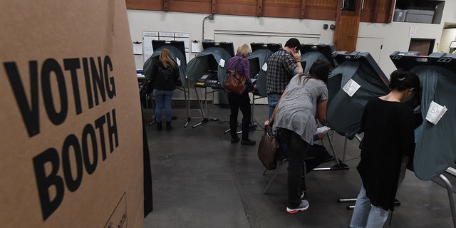 People vote at an Orange County polling station inside a fire station during the midterm elections in Huntington Beach, California, on November 6, 2018. (Photo: MARK RALSTON/AFP/Getty Images)