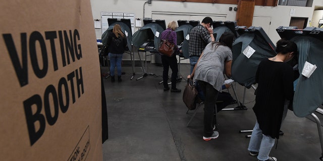 People vote at an Orange County polling station inside a fire station during the midterm elections in Huntington Beach, California, on November 6, 2018. (Photo: MARK RALSTON/AFP/Getty Images)