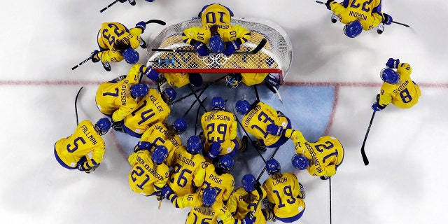 FILE - In this Feb. 2, 2018, file photo, players from Sweden gather before the preliminary round of the women's hockey game against the combined Koreas at the 2018 Winter Olympics in Gangneung, South Korea. (AP Photo/Kiichiro Sato, File)