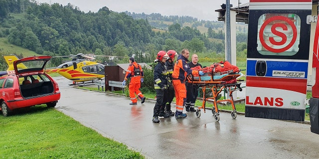 Rescue crews with the first people injured by a lightning strike that struck in Poland's southern Tatra Mountains during a sudden thunderstorm Thursday.