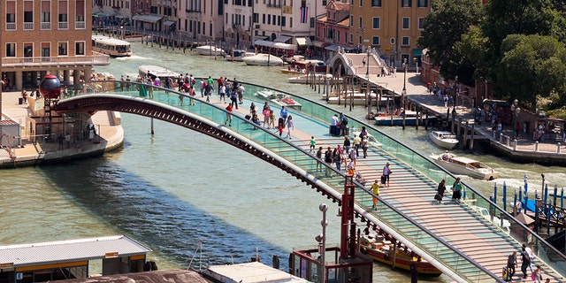 Venice, Italy - June 13, 2013: Venice cityscape and The Constitution Bridge (Ponte della Costituzione) over the Grand canal from above.