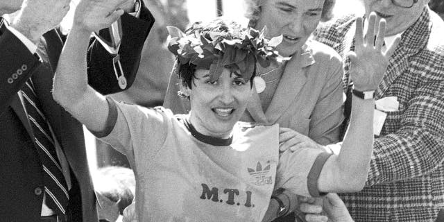 FILE - In this April 21, 1980 file photo, Rosie Ruiz waves to the crowd after after being announced as winner of the women's division of the Boston Marathon in Boston. Her title was stripped eight days later when it was found that she had not run the entire course. Ruiz died July 8, 2019 in Florida. She was 66. (AP Photo/File)