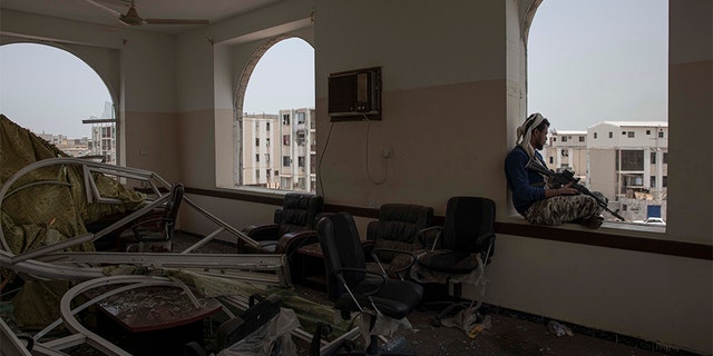 A soldier guards the site of a deadly attack inside the Sheikh Othman police station in Aden, Yemen, Thursday, Aug. 1, 2019. Yemen's rebels have fired a ballistic missile at a military parade in the southern port city of Aden as coordinated suicide bombings targeted the police station in another part of the city. The attacks killed at least 51 people and wounded dozens.