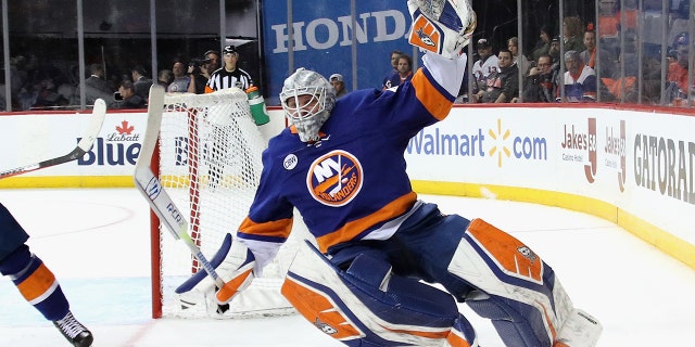 Robin Lehner #40 of the New York Islanders is tripped up against the Carolina Hurricanes in Game One of the Eastern Conference Second Round during the 2019 NHL Stanley Cup Playoffs at the Barclays Center on April 26, 2019 in the Brooklyn borough of New York City. (Photo by Bruce Bennett/Getty Images)