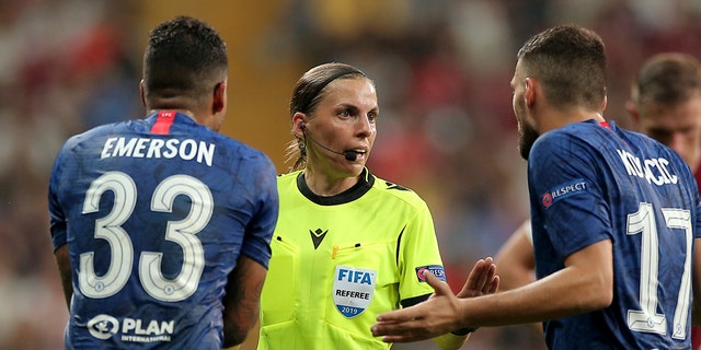 Referee Stephanie Frappart of France, center, discusses with Chelsea's Emerson Palmieri, left, and Chelsea's Mateo Kovacic during the UEFA Super Cup soccer match between Liverpool and Chelsea, in Besiktas Park, in Istanbul, Wednesday, Aug. 14, 2019. (AP Photo)