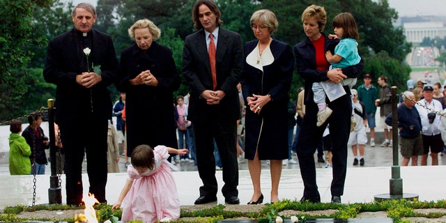 Robert F. Kennedy's granddaughter Saoirse Kennedy Hill places a white rose at the Eternal Flame, President John F. Kennedy's gravesite, at Arlington National Cemetery in Arlington, Va., June 6, 2000. Hill died Thursday at age 22.<br>
​​​​​​(Associated Press)