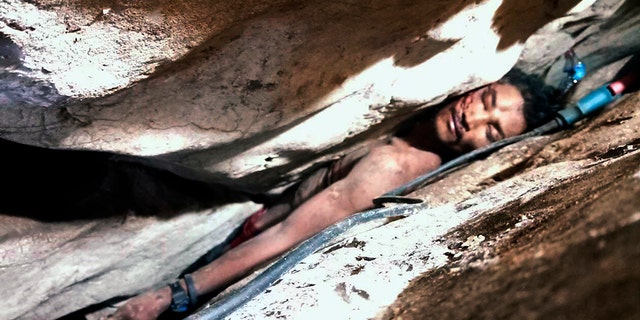 Sum Bora, 28, got stuck in the rock's hollow at Battambang province in northwestern of Phnom Penh, Cambodia.