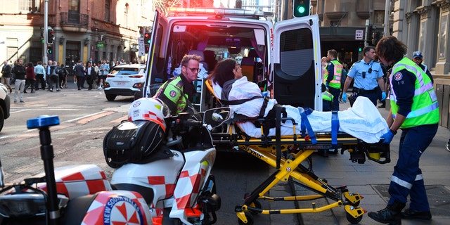 A women is taken by ambulance from Hotel CBD at the corner of King and York Street in Sydney, Australia Tuesday, Aug. 13, 2019.