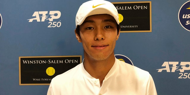 Tennis player Duckhee Lee, of South Korea, poses following his tennis match, Monday, Aug. 19, 2019, at the Winston-Salem Open in Winston-Salem, N.C. Lee became the first deaf professional to play in an ATP-level tennis tournament. (AP Photo/Joedy McCreary)