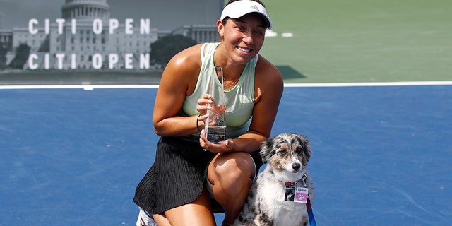 Jessica Pegula poses with a trophy and her dog Maddie after defeating Camila Giorgi, of Italy, in a final match at the Citi Open tennis tournament, Sunday, Aug. 4, 2019, in Washington. (AP Photo/Patrick Semansky)