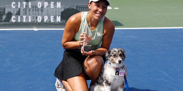 Jessica Pegula poses with a trophy and her dog Maddie after defeating Camila Giorgi, of Italy, in a final match at the Citi Open tennis tournament, Sunday, Aug. 4, 2019, in Washington. (AP Photo/Patrick Semansky)