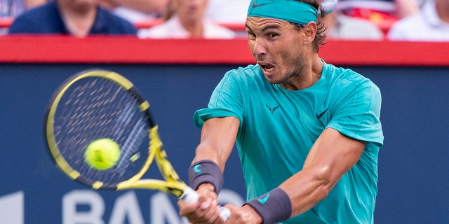 Rafael Nadal, of Spain, returns to Guido Pella, of Argentina, during the Rogers Cup men’s tennis tournament Thursday, Aug. 8, 2019, in Montreal. (Paul Chiasson/The Canadian Press via AP)