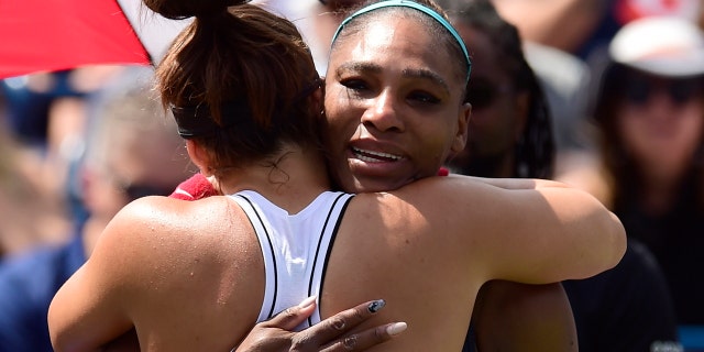 Canada's Bianca Andreescu, left, consoles Serena Williams, of the United States, after Williams had to retire from the final of the Rogers Cup tennis tournament in Toronto, Sunday, Aug. 11, 2019. (Frank Gunn/The Canadian Press via AP)