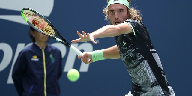 Stefanos Tsitsipas, of Greece, returns a shot to Andrey Rublev, of Russia, during the first round of the US Open tennis tournament Tuesday, Aug. 27, 2019, in New York. (AP Photo/Kevin Hagen)