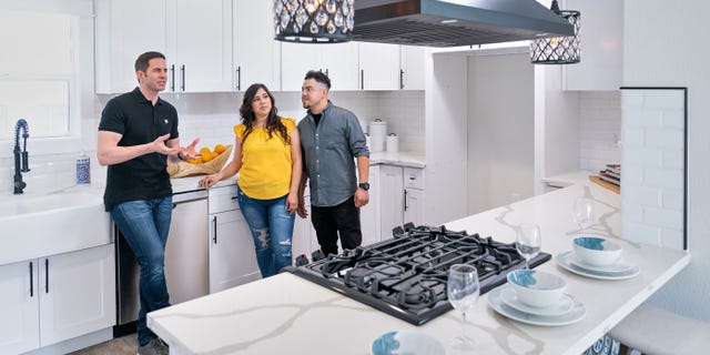 On Flipping 101, house flipping guru, Tarek El Moussa (L) mentors first time home flippers Victor Quinones and Deanna Esqueda as they prepare for the Open House of their first home flip.