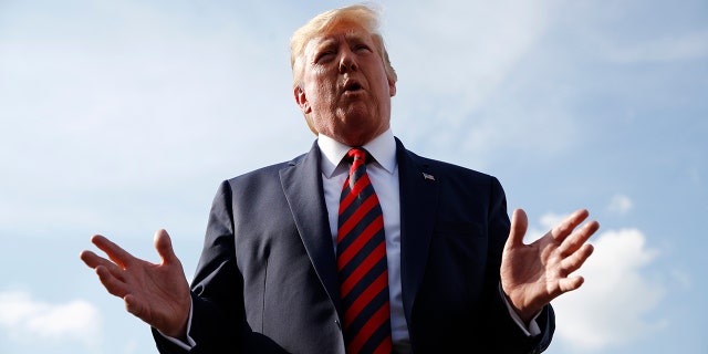 Former President Donald Trump speaks with reporters before boarding Air Force One with first lady Melania Trump at Morristown Municipal Airport in Morristown, N.J., Sunday, Aug. 18, 2019, en route to Andrews Air Force Base, Md. (AP Photo/Patrick Semansky)