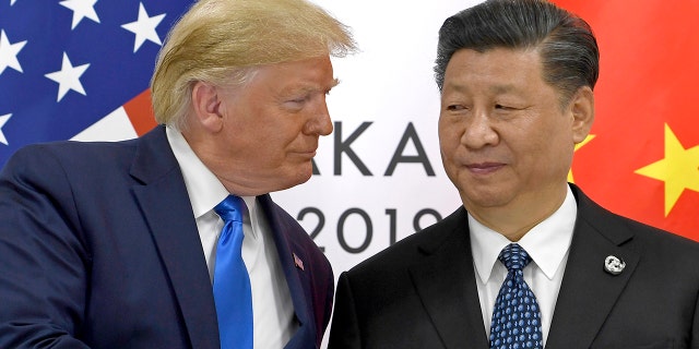 FILE - In this June 29, 2019, file photo, U.S. President Donald Trump, left, shakes hands with Chinese President Xi Jinping during a meeting on the sidelines of the G-20 summit in Osaka, western Japan. Facing another U.S. tariff hike, Xi is getting tougher with Washington instead of backing down. Both sides have incentives to settle a trade war that is battering exporters on either side of the Pacific and threatening to tip the global economy into recession. (AP Photo/Susan Walsh, File)