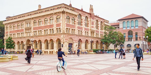 Students walk and bike at the University of Southern California campus in Los Angeles.